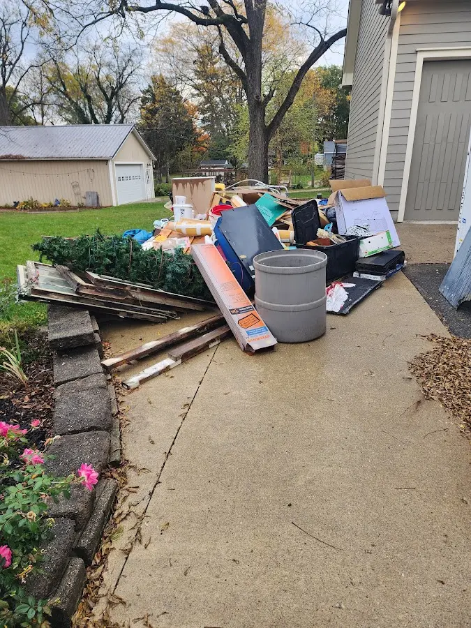 Dumpster being loaded with debris for Estate Cleanout Dumpster Rental in Granite Falls